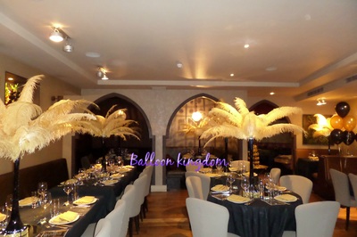 gold with black vase ostrich feather centerpiece hire