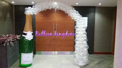 giant champagne bottle with bubbles arch