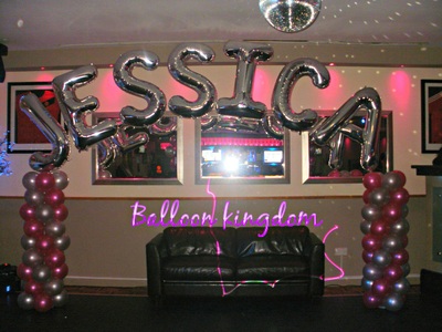 pink and silver balloon columns with name arch
