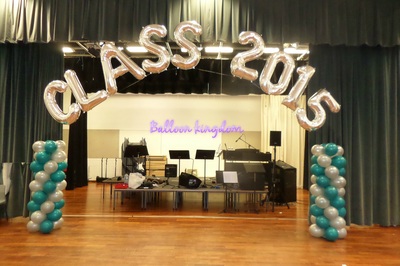 teal and silver balloon columns with name arch