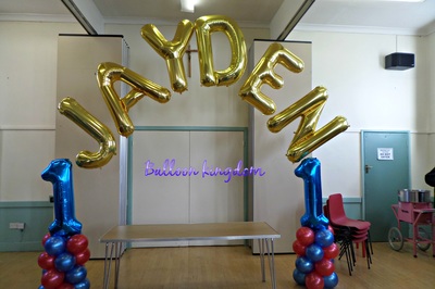 number 1 balloon columns with name arch