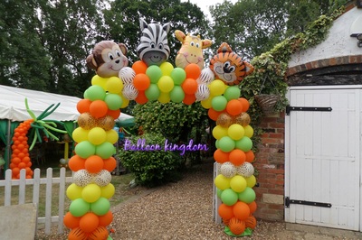 Jungle themed balloon arch with foil balloon character  on top