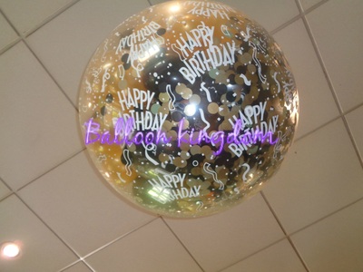 popping exploding balloon filled with gold and black  mini balloons and confetti