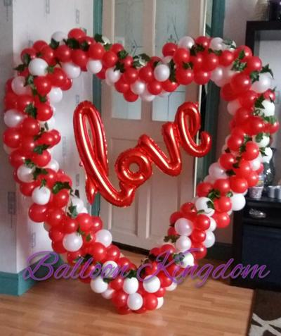 red and white organic balloon heart sculpture with love foil balloon banner and ivy