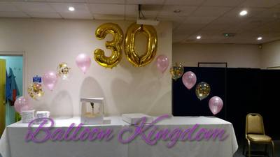 balloon arch with confetti balloons and giant number centre 