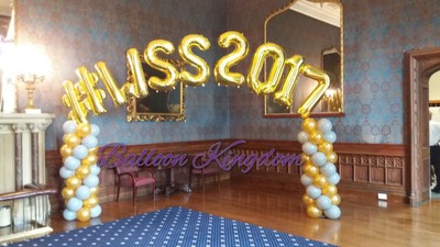 gold and silver balloon columns with name arch