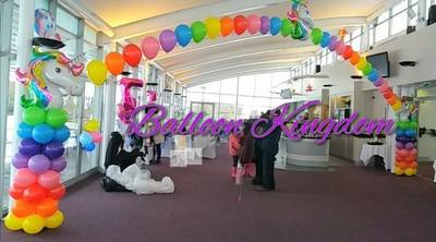 Rainbow unicorn balloon columns and pearl arch at stockley golf club